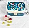 Dark blue plastic lunch box with cream and dark blue lid featuring print of fairies amongst flowers