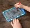 Child drawing on Fairies in the Garden Magic Slate