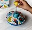 Colourful spinning top toy with a box in the background