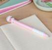 Retractable ballpoint pen in pink showing a cute cat sitting atop