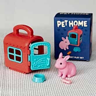 pet carrier with pink rabbit and packaging box in the background