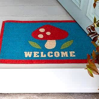 Colourful doormat featuring red mushroom and a welcome letter print 