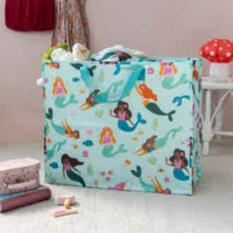large rectangular bag with a light blue background, featuring colourful mermaid print