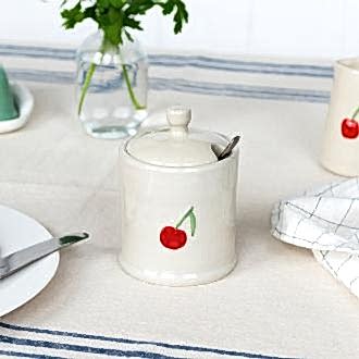 stoneware sugar pot with lid on, featuring a red cherry print and a small handle on top