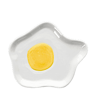 White ceramic trinket dish shaped like a fried egg with yellow yolk design