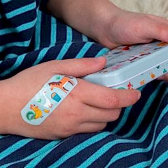 Plaster applied to a kids' hand with a farmyard-themed design.