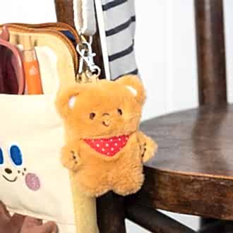 Light brown plush teddy bear keychain with a red polka-dotted bandana, metal clasp for attachment