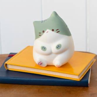 Green and white squidgy stress cat in a sitting design
