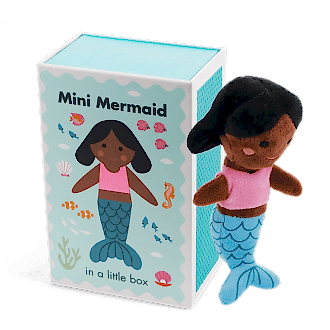 Mini mermaid soft toy placed beside a small illustrated box with mermaid design