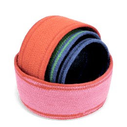 Four woven storage baskets in varying sizes and colours stacked