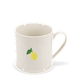 Stoneware mug featuring a yellow lemon print with green leaves and handle
