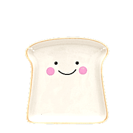 Ceramic trinket dish shaped like a slice of bread with a smiling face and pink cheeks
