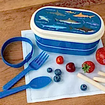 Dark blue plastic bento box with cream lid and middle tray featuring pictures of sharks