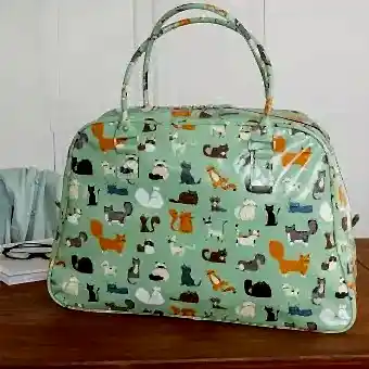 Light green oilcloth weekend bag with illustrations of cats