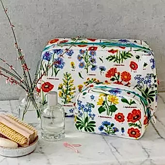 White oilcloth wash bag and makeup bag collection with wild floral pattern