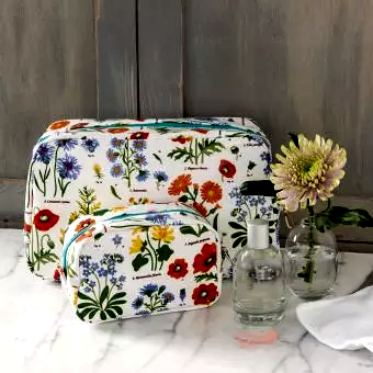 White oilcloth wash bag and makeup bag collection with wild floral pattern