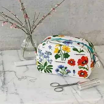 White oilcloth makeup bag with images of wild flowers