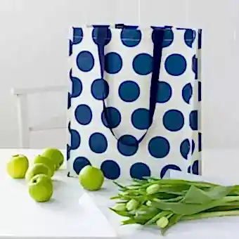 Recycled plastic shopping bag navy blue circles cream background