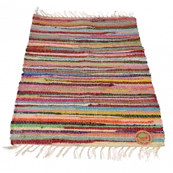 Multicoloured handloomed cotton rug laid flat with swing tag showing