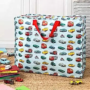 Road Trip jumbo bag alongside toy cars/vehicles, pile of storybooks and kaleidoscope