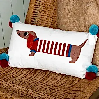 Embroidered cushion with pom poms - Sausage Dog