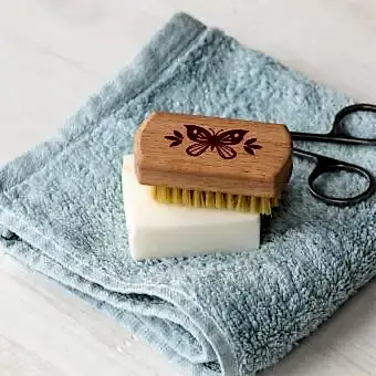 wooden nail brush featuring a butterfly illustration