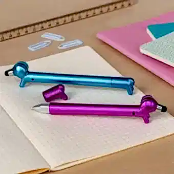 blue and pink sausage dog stylus ballpoint pen, lying on a notebook