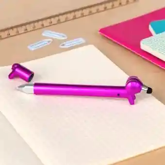 Pink sausage dog stylus ballpoint pen with cap off, lying on a notebook
