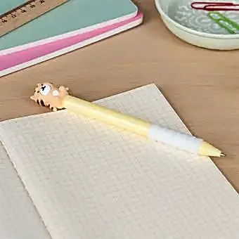 Retractable ballpoint pen in yellow showing a cute tiger sitting atop 