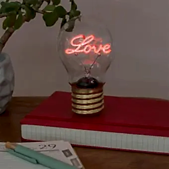 Love usb light bulb placed on a book with light on