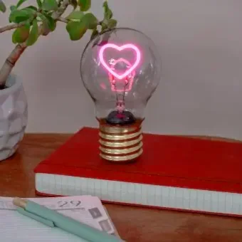 Heart usb light bulb placed on a book with light on