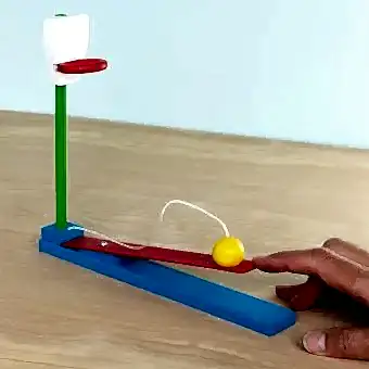 wooden tabletop basketball game with a yellow ball