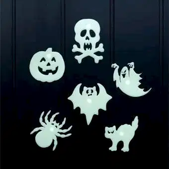 Six assorted Halloween-themed glow-in-the-dark shapes on a black background.