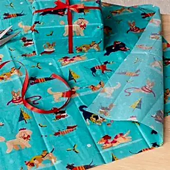 festive friends tissue paper feature illustrations of dogs in winter clothing