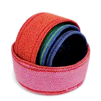 Four woven storage baskets in varying sizes and colours stacked