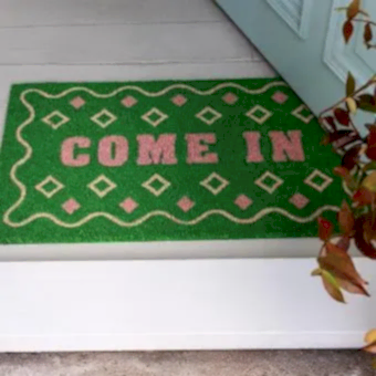 doormat featuring come in print with green background