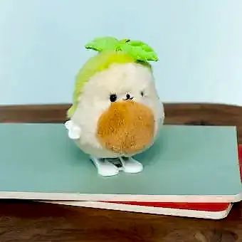Plush avocado-shaped wind-up toy with green leaves 