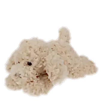 Light brown plush dog toy lying down with floppy ears and soft fur