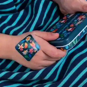 Plaster applied to a kids' hand with a fairies in the garden-themed design.