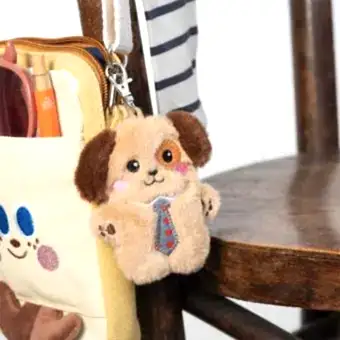 dog-shaped plush keyring wearing a tie with brown ears
