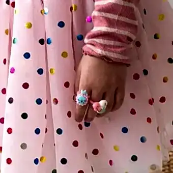 Assorted colourful rings with animal, mermaid, flower, and fruit designs