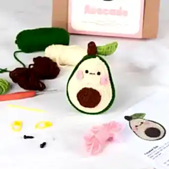 Avocado crochet kit with packaging and finished crocheted avocado beside it