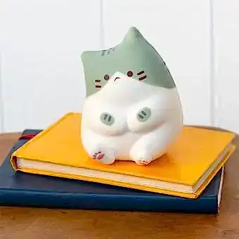 Green and white squidgy stress cat in a sitting design