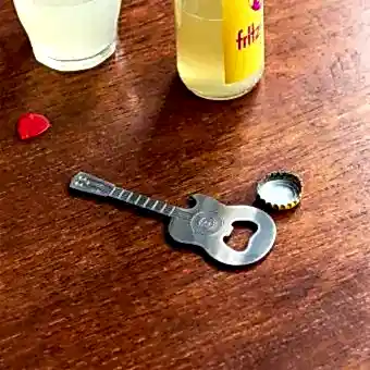 Guitar-shaped fridge magnet with built-in bottle openers in silver