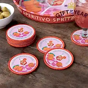 Four round coaster with Italian Aperitivo Spritz design in a storage tin