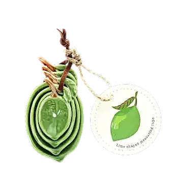 Stackable ceramic measuring spoons shaped like green leaves with brown stem handles with tag