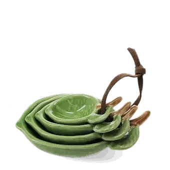stackable ceramic measuring spoons shaped like green leaves with brown stem handles