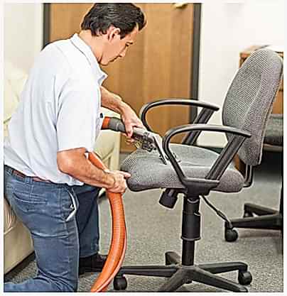 man doing chair vacuuming man doing chair vacuuming