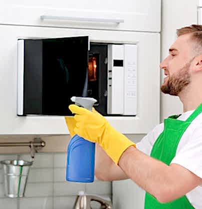 man cleaning microwave man cleaning microwave